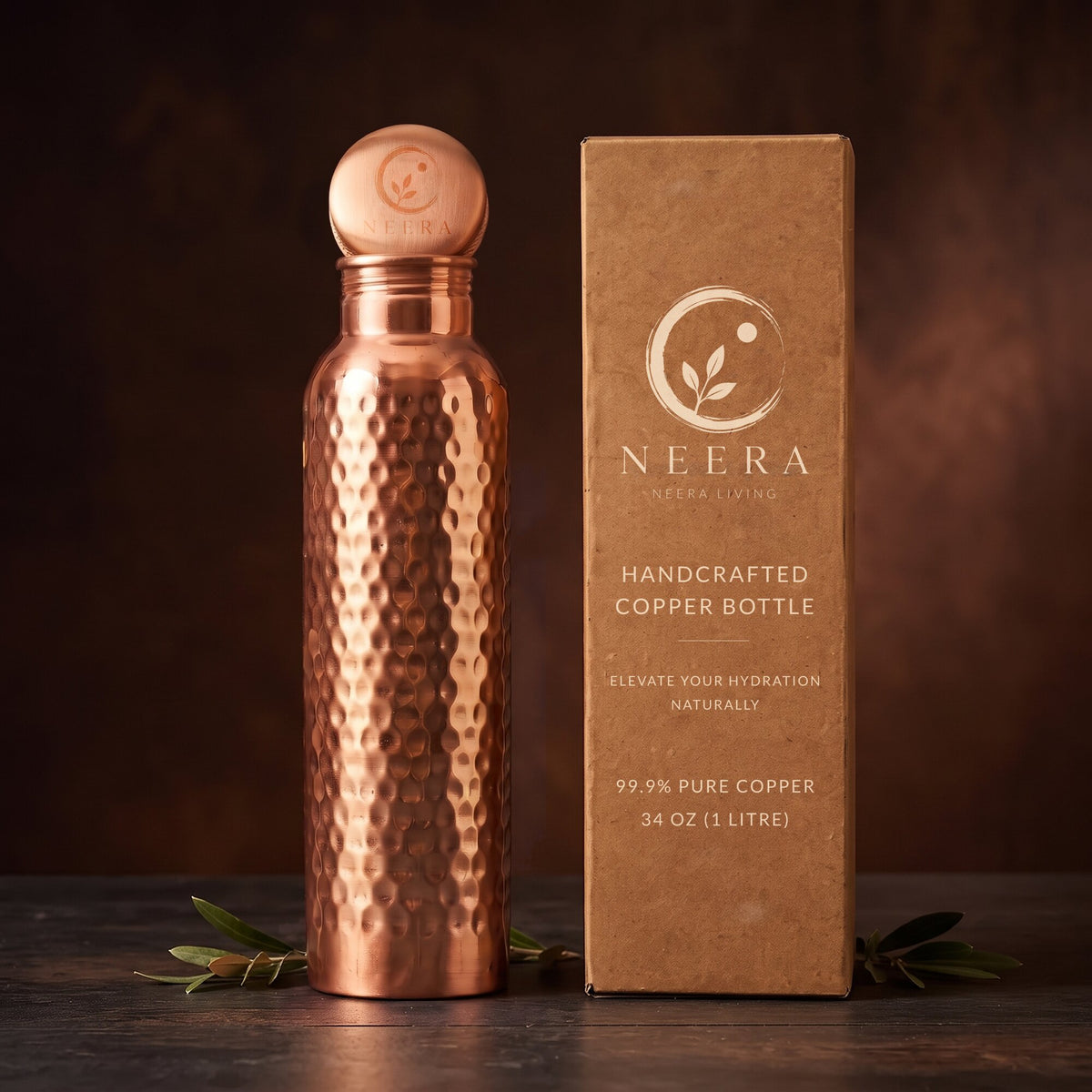 Hand-hammered 34 oz copper water bottle with engraved Neera cap next to kraft gift box - 99.9% pure copper